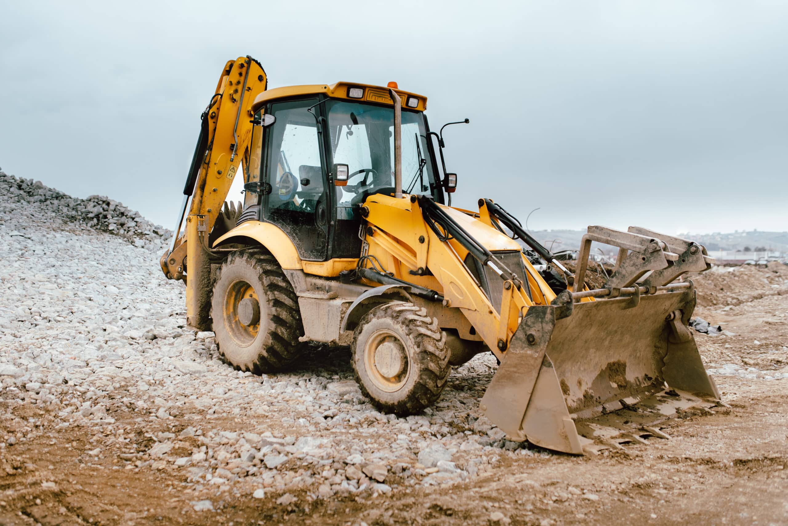 Industrial road construction site, highway building. Heavy duty machinery backhoe excavator on site