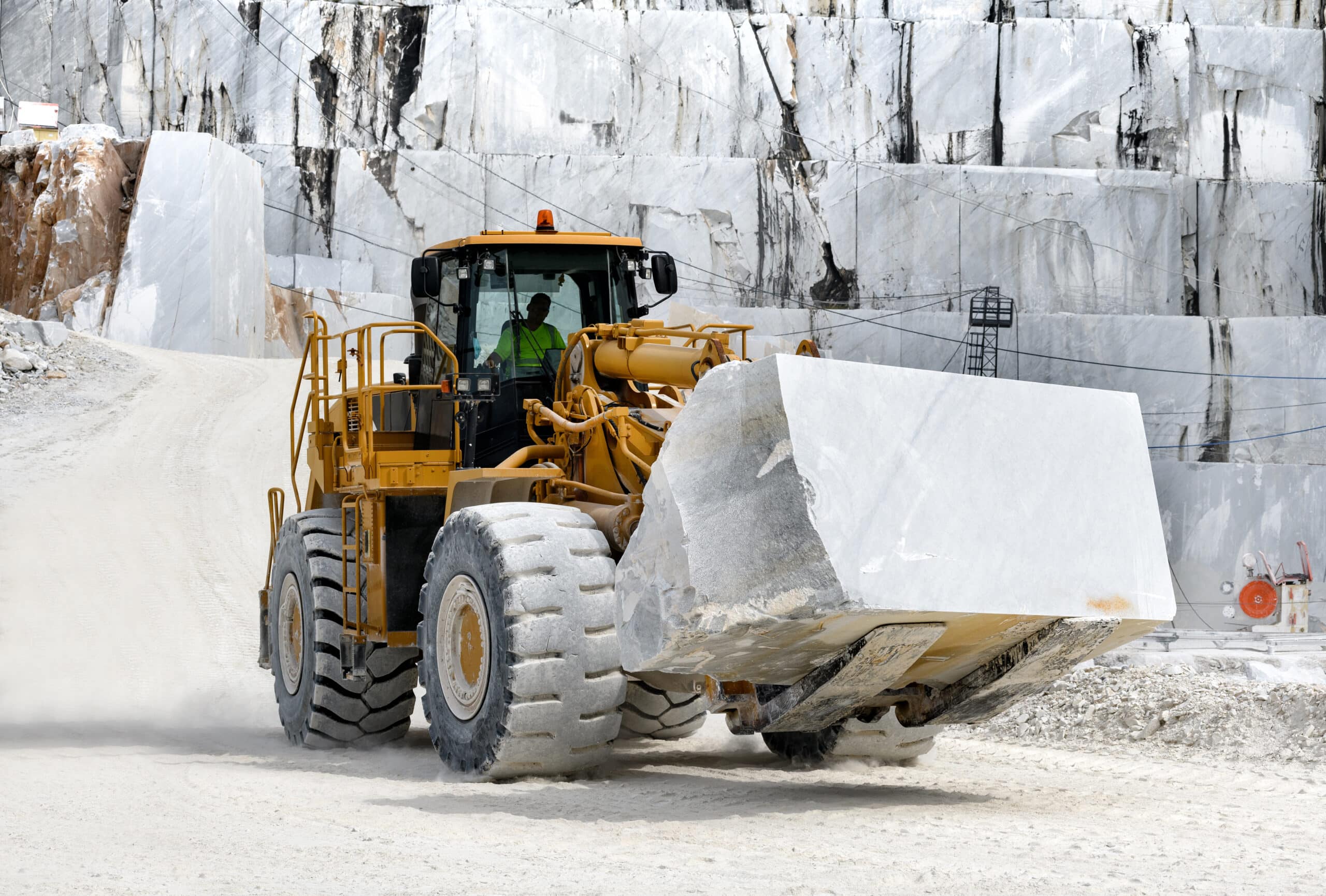 Heavy duty front end loader moving marble